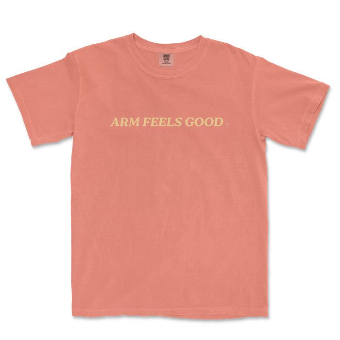 Pink Comfort Colors T-shirt with "ARM FEELS GOOD" text in cream-colored font across the front.