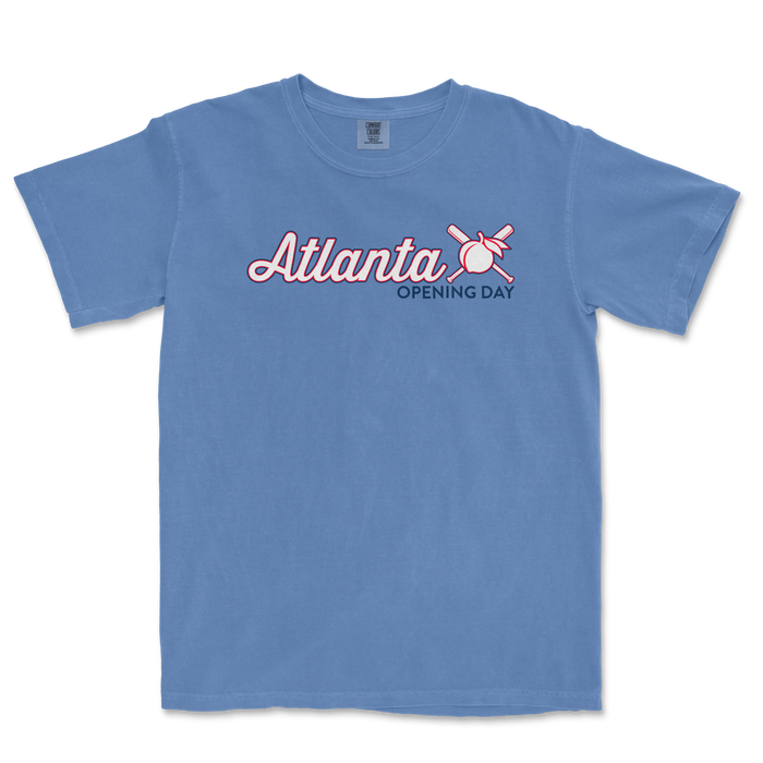 Blue Comfort Colors T-shirt featuring "Atlanta Opening Day '25" text with a baseball, bat, and crossed sticks graphic.