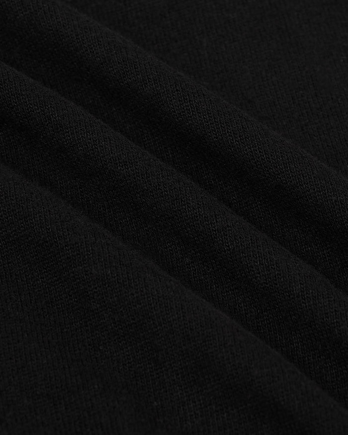 Close-up texture of soft black fabric highlighting the quality and weave of the Black Heavyweight Curved Hem Crew men's basics garment.