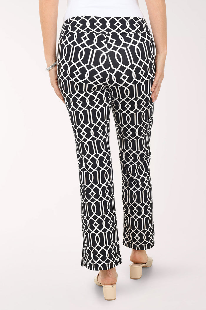 Person wearing black and white patterned pants on a white background