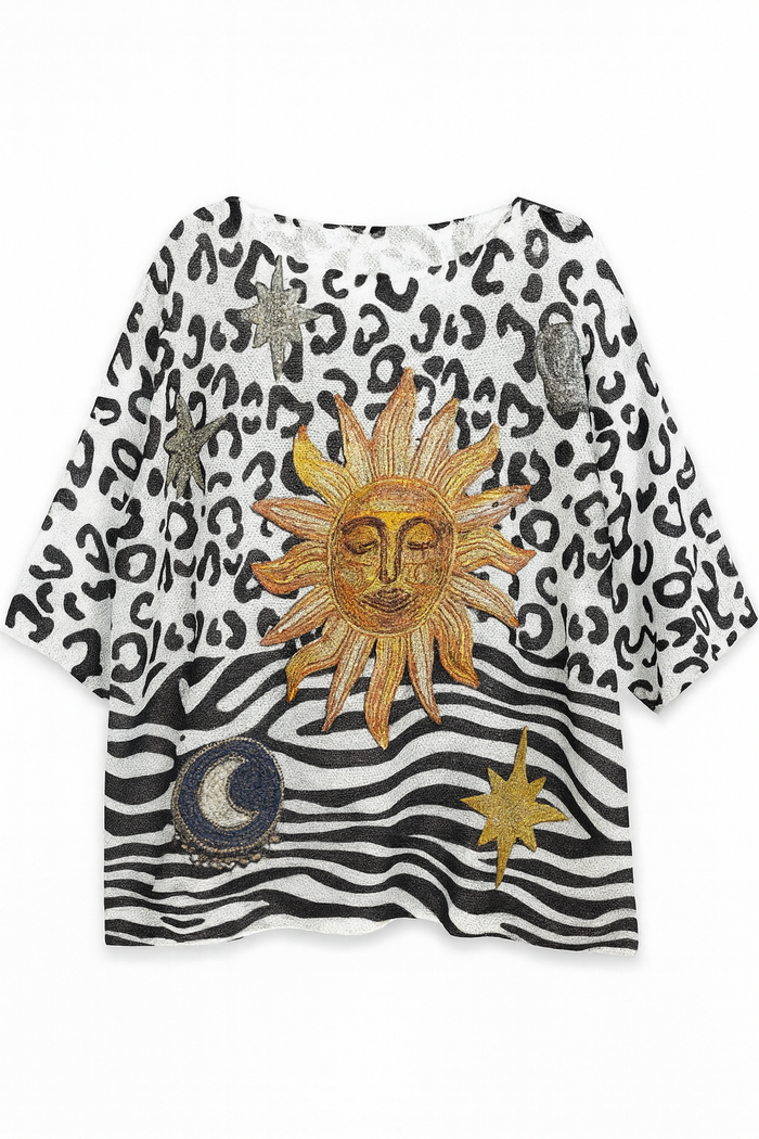 Black and white graphic knit top featuring a bold sun and moon design with leopard print and mixed stripe detailing.