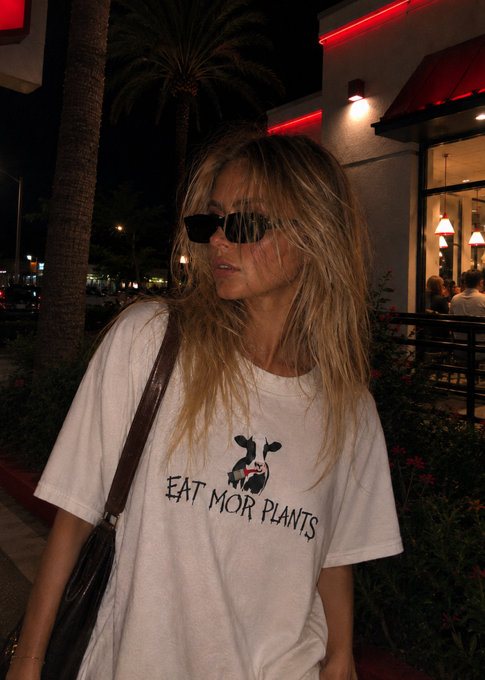 Girl wearing an eat mor plants cow t shirt vegan streetwear