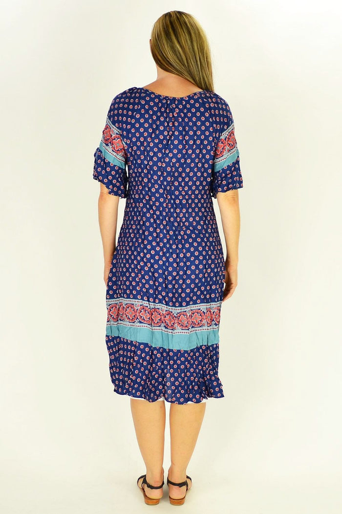 Flower in the Meadow tunic dress by Cafe Latte displayed in a natural setting, featuring a floral pattern and lightweight fabric.