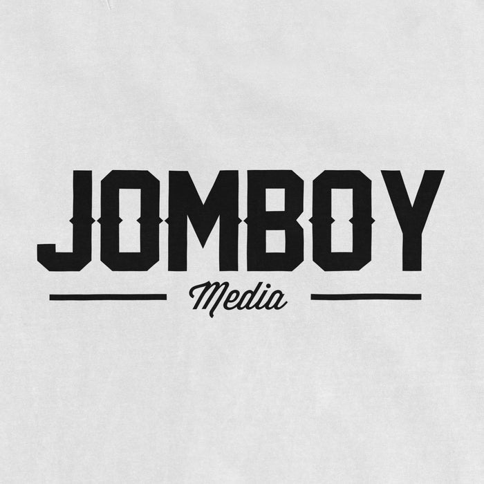 Jomboy Media logo printed on a Comfort Colors T-shirt in black and white, featuring bold uppercase "JOMBoy" and cursive "Media" text.