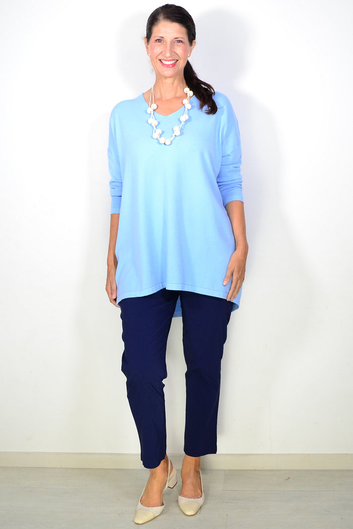 Light blue wool blend fine knit tunic top by Cali&Co, close-up of soft fabric and relaxed fit on a mannequin.