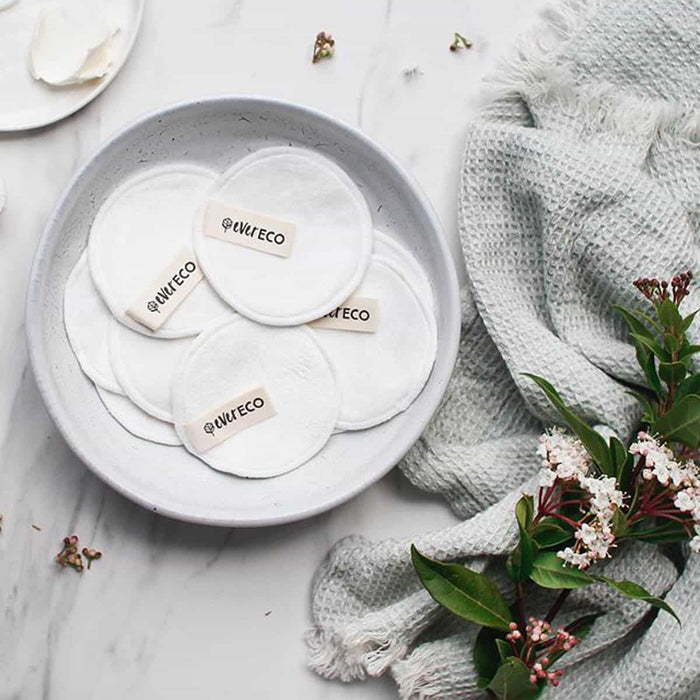 Bowl of ever eco facial pads styled on a bathroom counter.