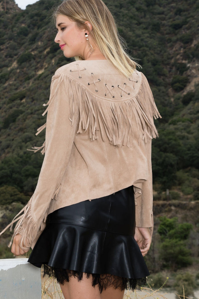 Stone suede-effect fringe lace-up jacket with metal grommet accents, sleeve and back fringe, and an asymmetrical hem.