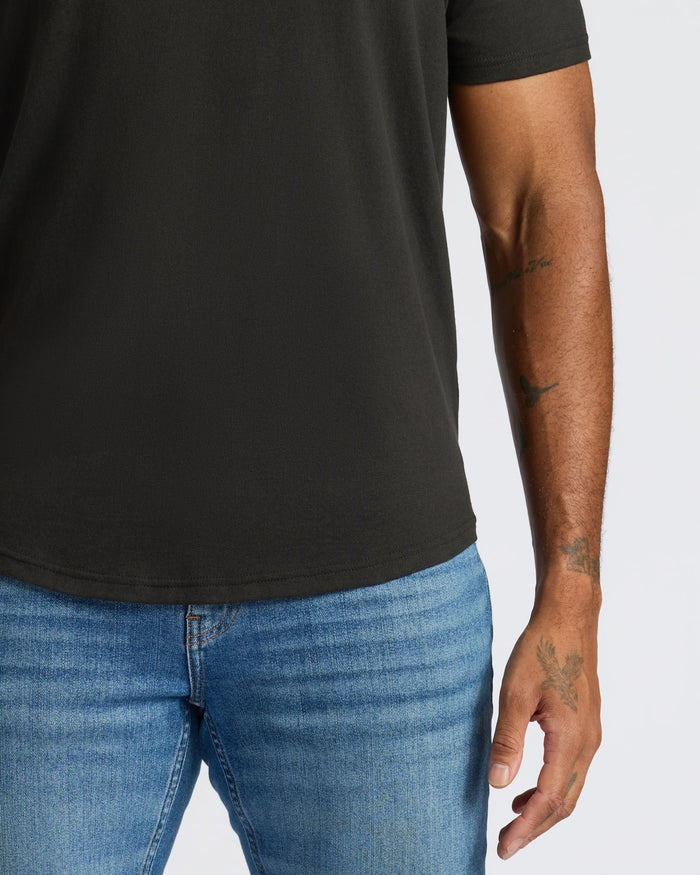 Person wearing a black t-shirt and blue jeans on a white background