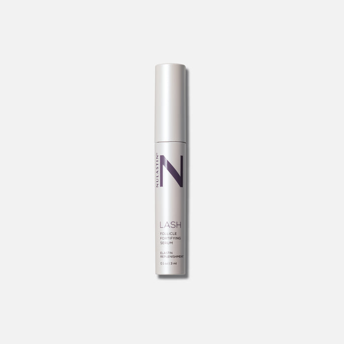 Front view of LASH Follicle Fortifying Serum tube showing white metallic packaging and purple N logo on a light gray background