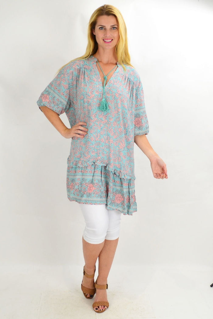 Style Fashion Aqua Bell Ruffle Tunic Top with flowy fabric and ruffled neckline, shown on a hanger against a white background.