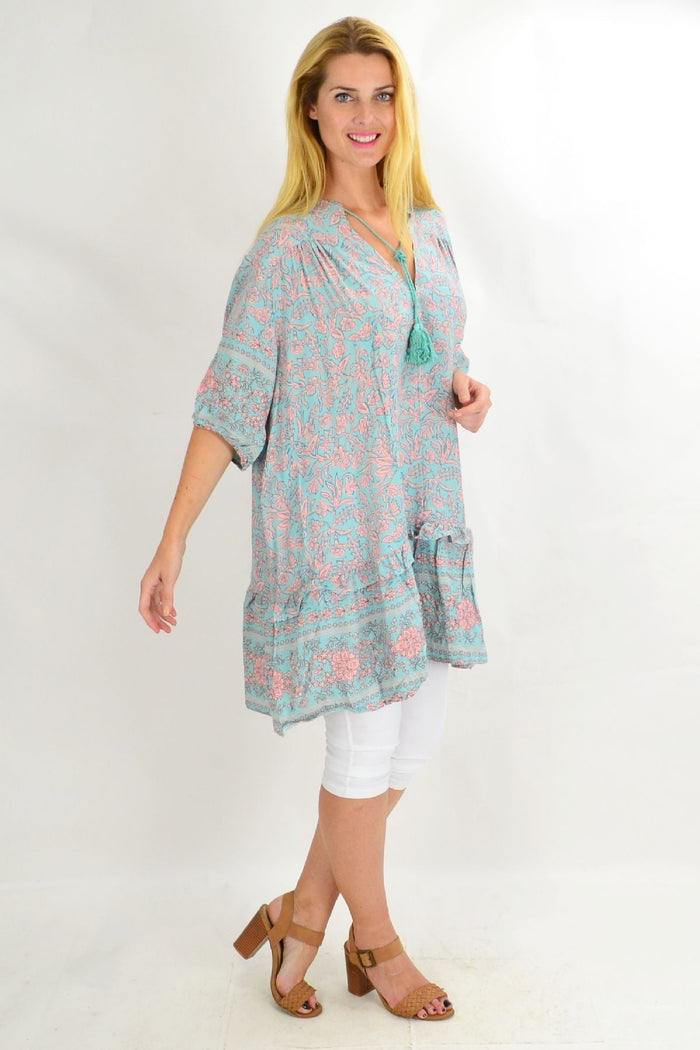 Aqua Bell Ruffle Tunic Top by Style Fashion featuring flowy fabric, ruffled details, and a relaxed fit on a mannequin.