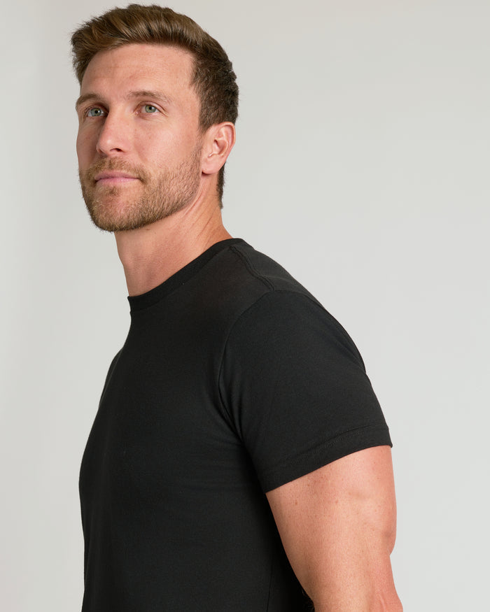 Man wearing a black t-shirt against a plain background