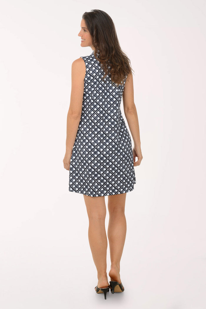 Woman wearing a sleeveless dress with a geometric pattern on a white background