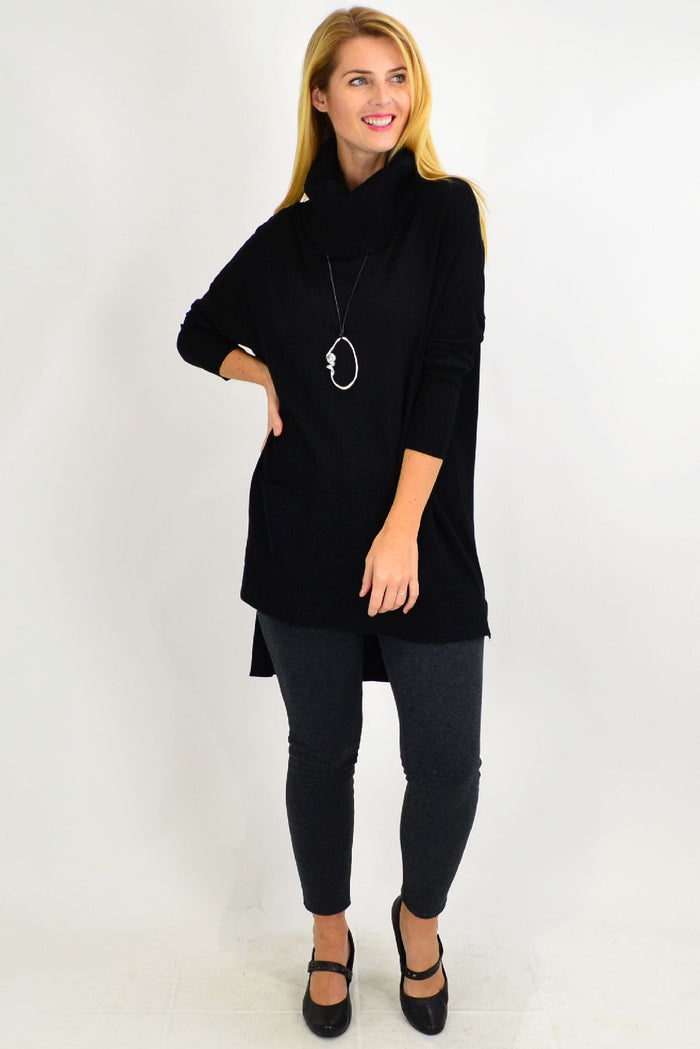 Black Taylor Winter Knit Tunic by Cali&Co, featuring long sleeves and a cozy knit texture, displayed on a hanger.