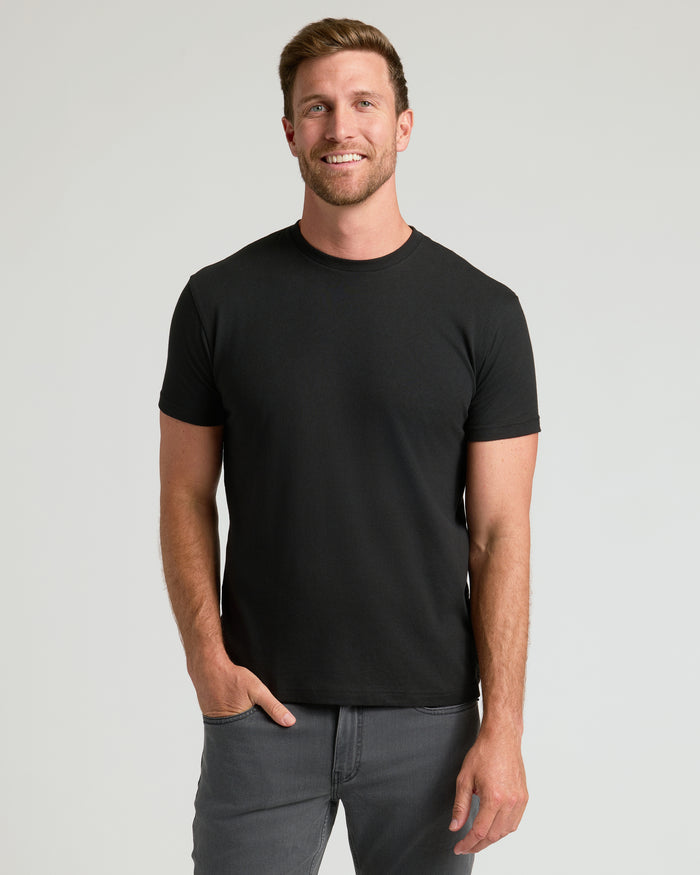 Man wearing Classic Crew 10-Pack black T-shirt and gray jeans.