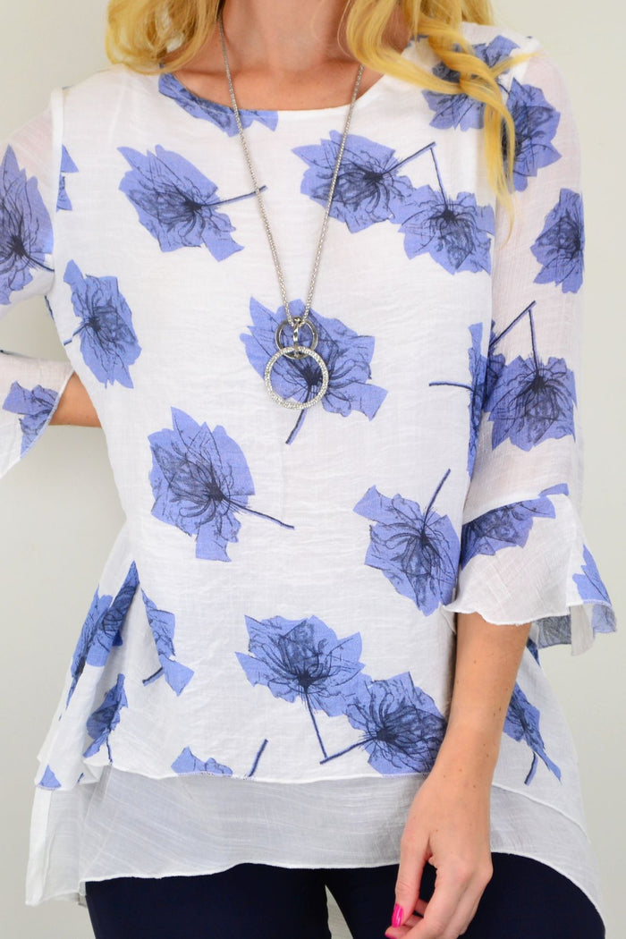 Blue maple leaf layered tunic top by Caroline Morgan, featuring a flowy fabric and layered design, shown on a hanger.