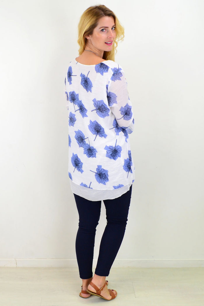 Blue maple leaf layered tunic top by Caroline Morgan, featuring a flowy design and detailed leaf pattern, displayed on a hanger.