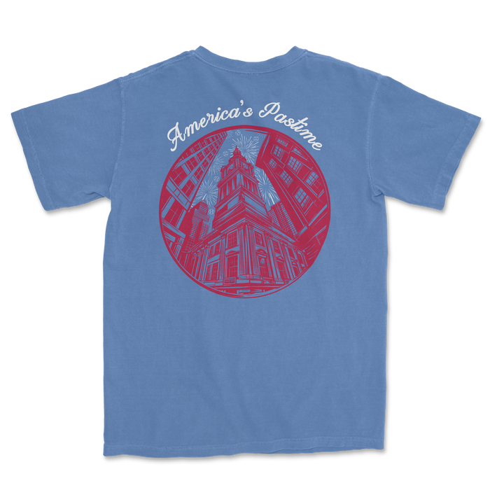 Blue t-shirt featuring a circular graphic of a historic building with "America's Pastime" text above.