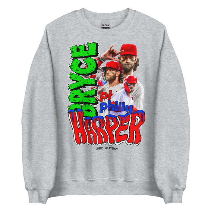 Gray crewneck sweatshirt featuring multiple images of Bryce Harper in a baseball uniform with red helmet and cap, surrounded by colorful, graffiti-style text.