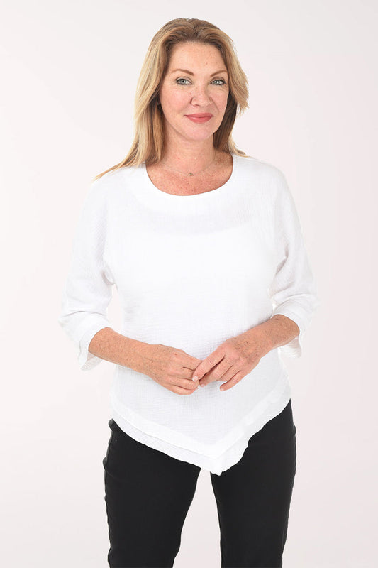 Woman wearing a white sweater and black pants on a white background