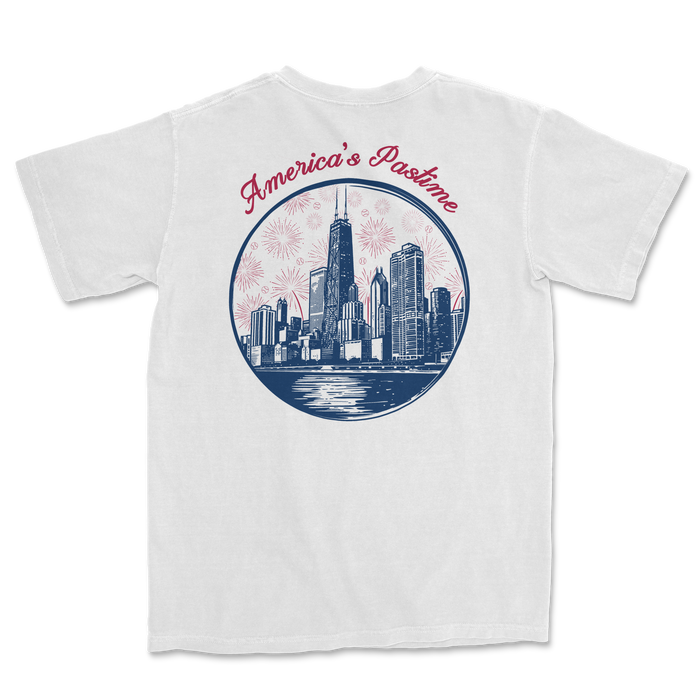 White t-shirt featuring a graphic of a city skyline with "America's Pastime" text and fireworks design.