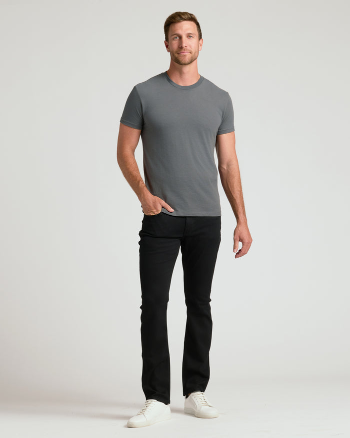 Man in Classic Crew Neck 6-Pack T-shirt, black jeans, white sneakers.