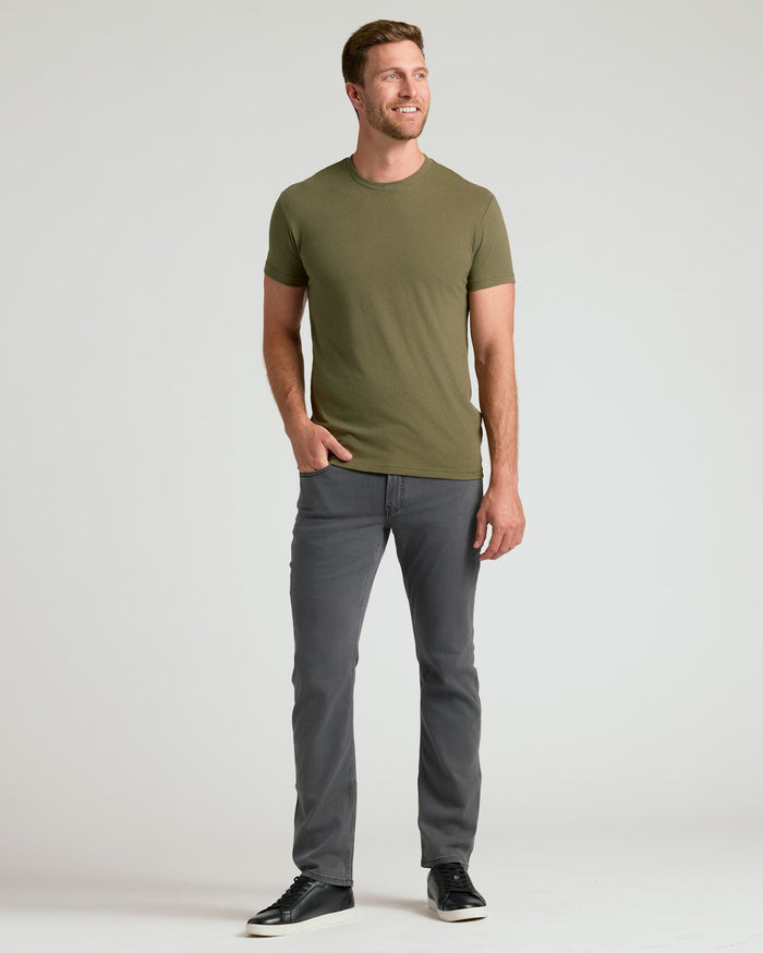 Man wearing Classic Crew Neck 6-Pack t-shirt and slim-fit jeans.