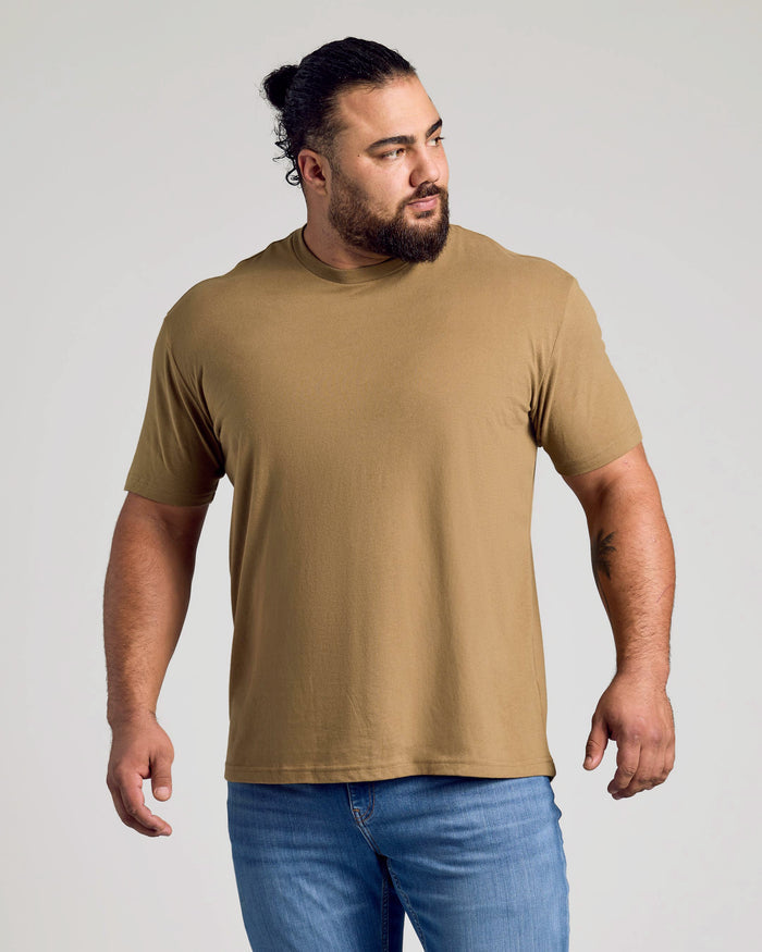 Man wearing Tan 499 Classic Crew Neck with blue jeans.