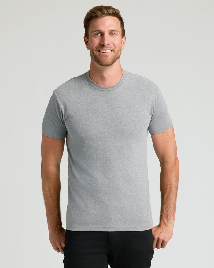 Man wearing Classic Crew Neck 6-Pack T-shirt, smiling.