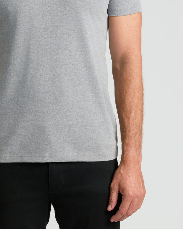 Person wearing Classic Crew Neck T-shirt over black pants.