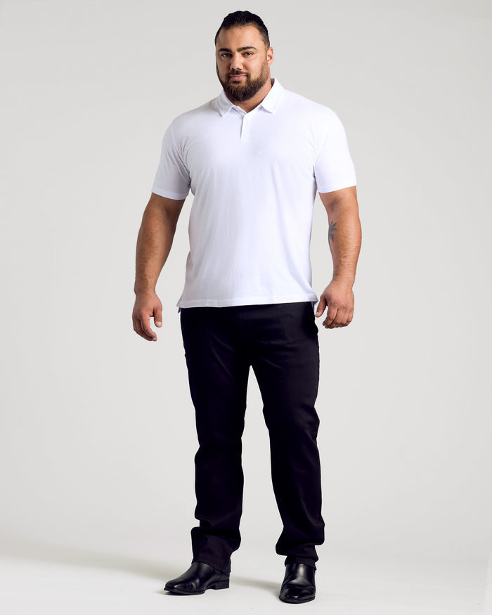 Man wearing The Light Indigo Short Sleeve Polo 3-Pack, relaxed posture.