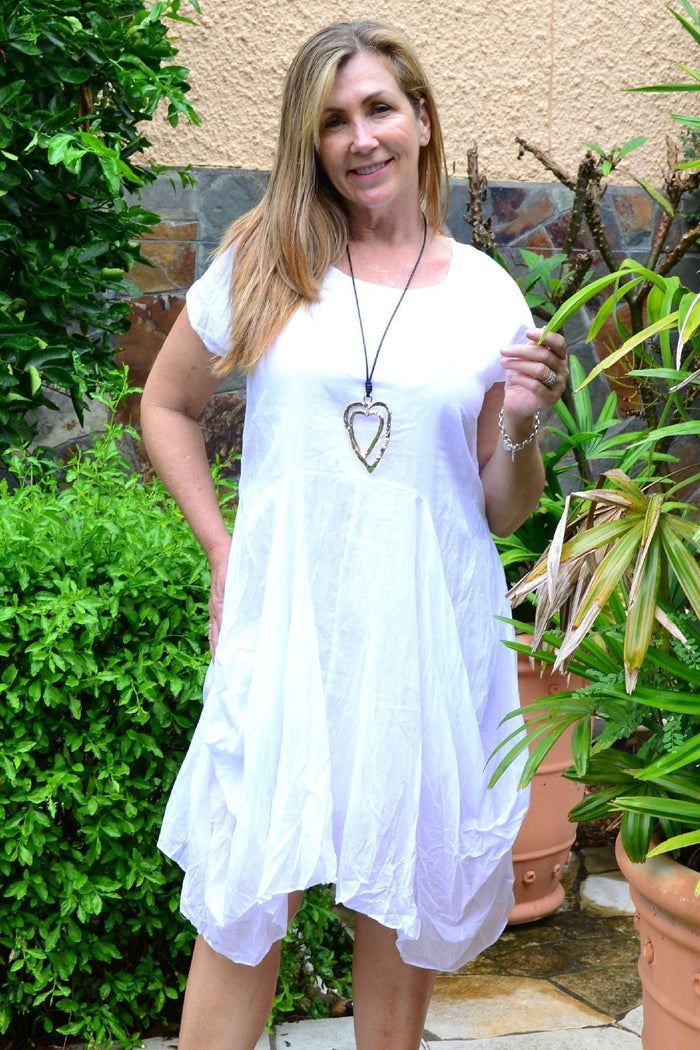 White cotton Sophia tunic dress by Wishstone, featuring a relaxed fit and stylish neckline, showcased on a model.