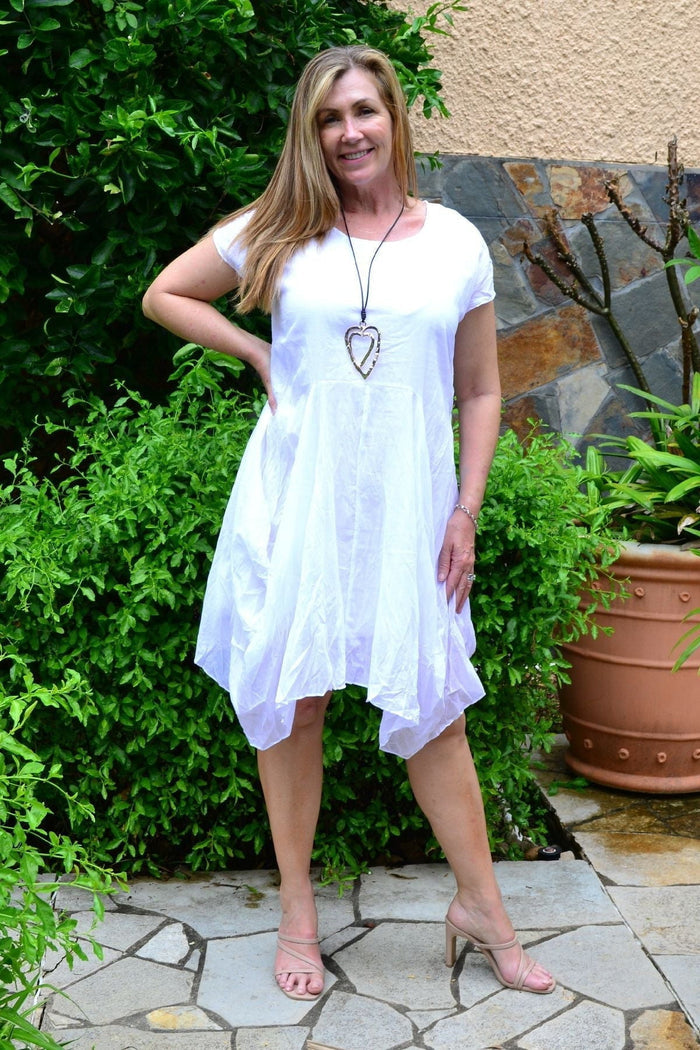 White cotton Sophia tunic dress by Wishstone, featuring a relaxed fit and simple design, displayed on a hanger.