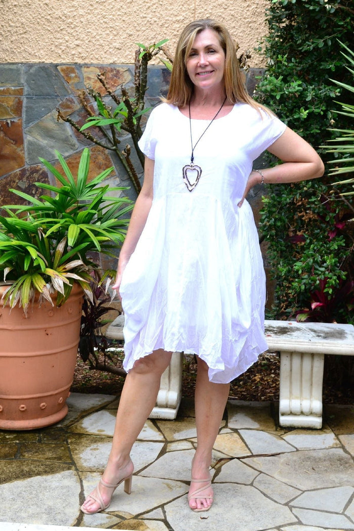 White cotton Sophia tunic dress by Wishstone, featuring a relaxed fit and stylish design, displayed on a hanger.