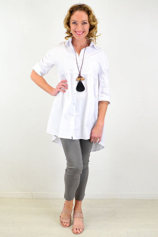 White Hourglass tunic shirt with a relaxed fit, featuring a classic collar and long sleeves, displayed on a neutral background.