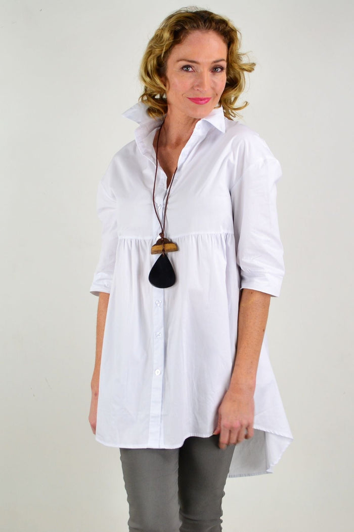 White trendsetting tunic shirt by Hourglass, featuring a sleek, crisp design with a relaxed fit and stylish neckline.