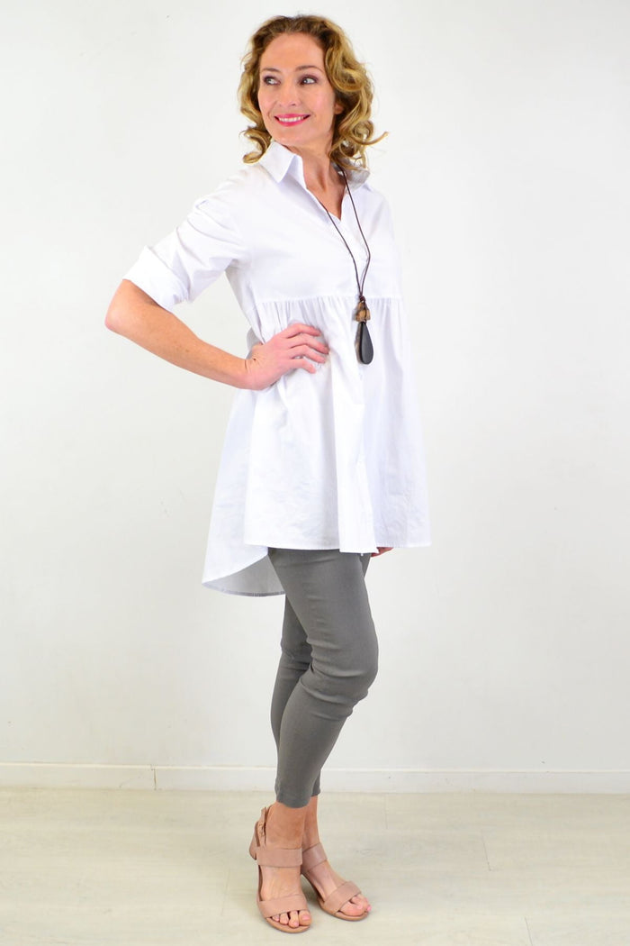 White tunic shirt by Hourglass featuring a trendy, crisp design with a relaxed fit and stylish neckline.