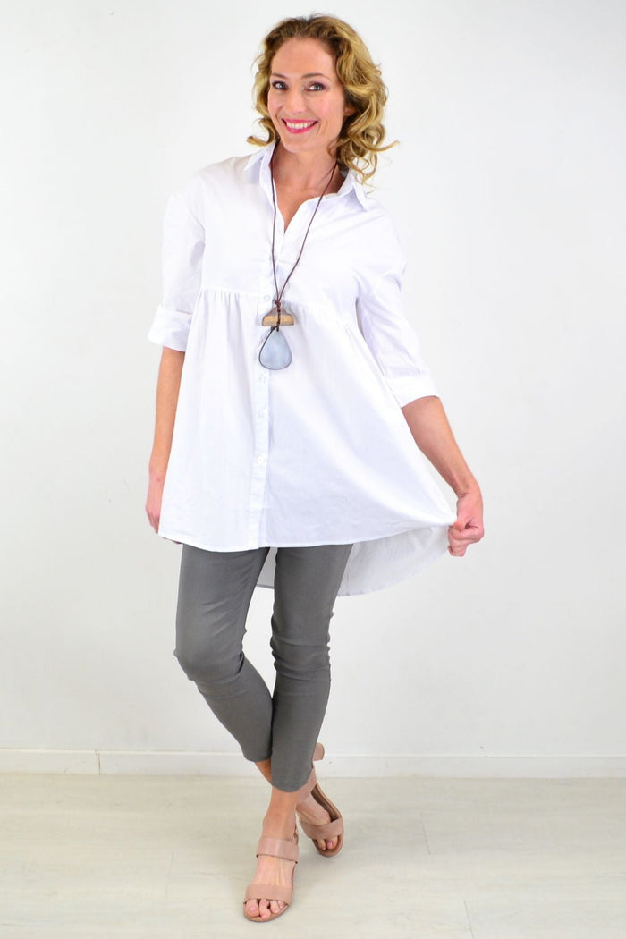 White trendsetting tunic shirt by Hourglass, featuring a stylish, crisp design with a relaxed fit and modern neckline.