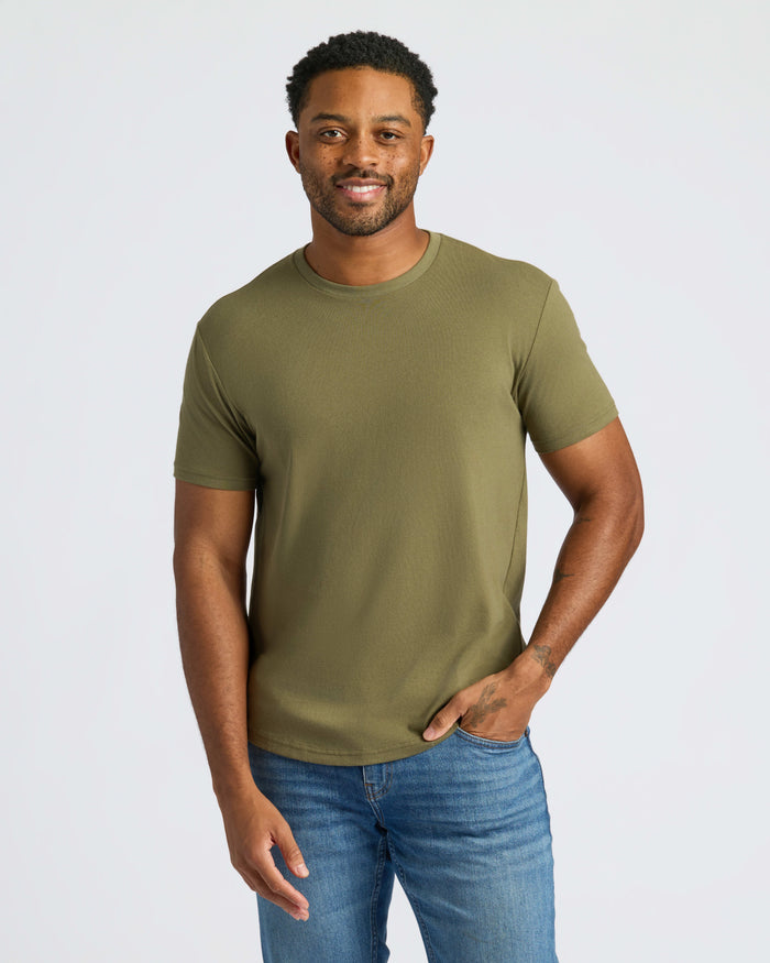 Man wearing Military Green Curved Hem Classic Crew Neck, smiling, with relaxed posture.