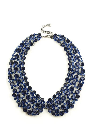 Dark blue statement collar necklace with layered rows of faceted stones and an adjustable chain.