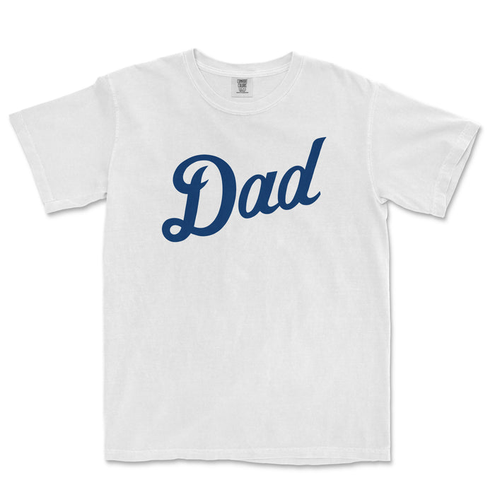 White Comfort Colors t-shirt with "Dad" written in bold blue script across the front, celebrating Detroit baseball dads.