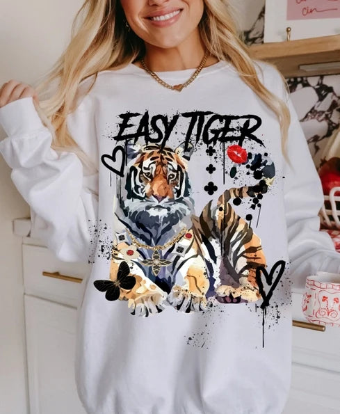 White long sleeve graphic tee featuring a bold tiger print and playful text accents on the front.