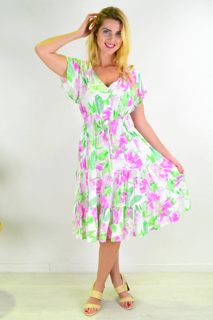 Floral tiered tunic dress from New U Collection, featuring a flowy design with colorful floral patterns and tiered layers.