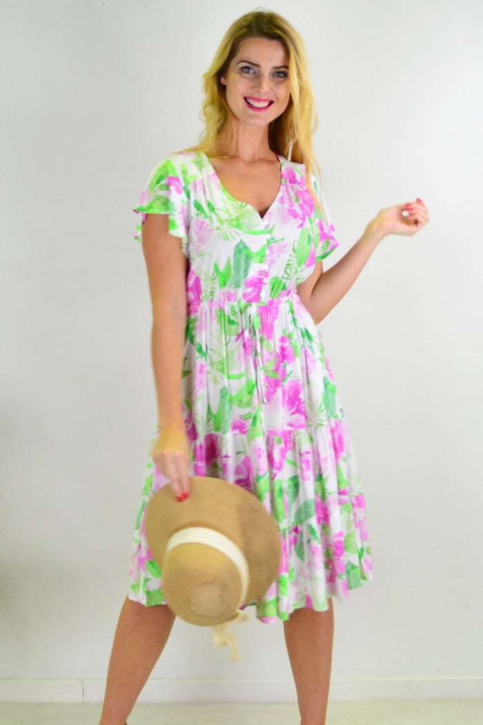 Floral tiered tunic dress from New U Collection with flowing fabric and vibrant flower print, displayed on a hanger.