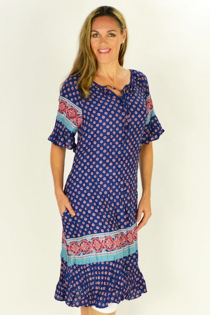 Flower in the Meadow tunic dress by Cafe Latte, featuring a floral pattern and lightweight fabric, displayed on a hanger.