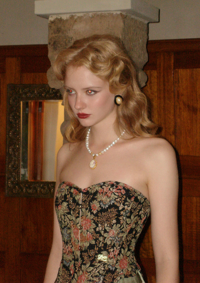 "Flower & Mirror" Close-up of black satin corset fabric and intricate floral motifs