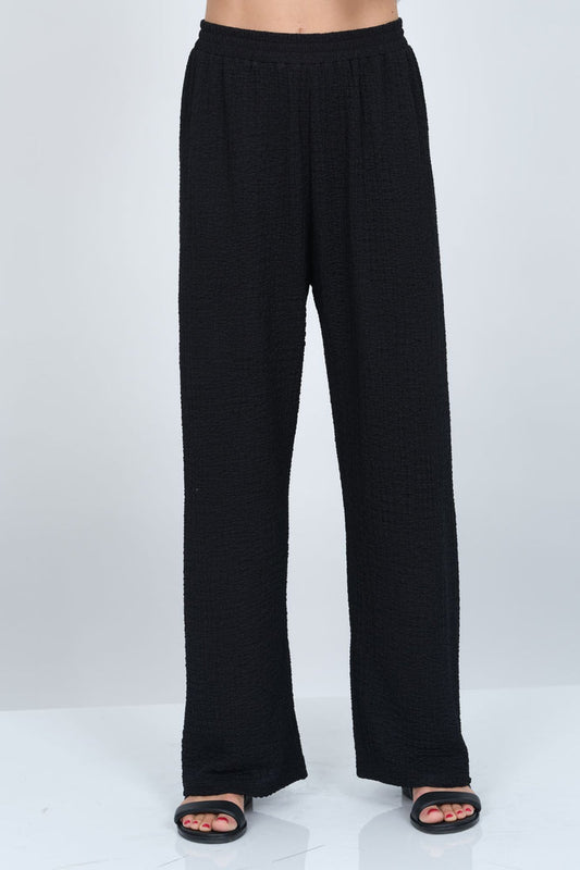 Women’s black waffle knit wide leg pull-on pant by LIOR with relaxed fit and soft textured fabric