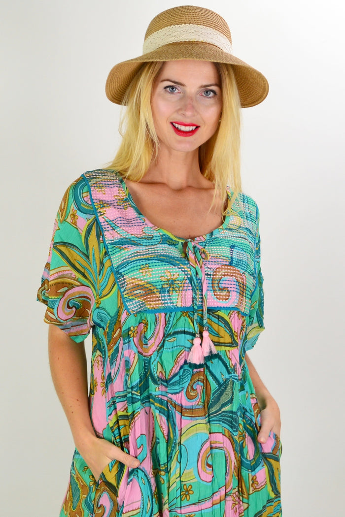 Orientique Mennagio Boho Bib Dress Tunic displayed on a hanger, showcasing its lightweight fabric and relaxed bohemian style.