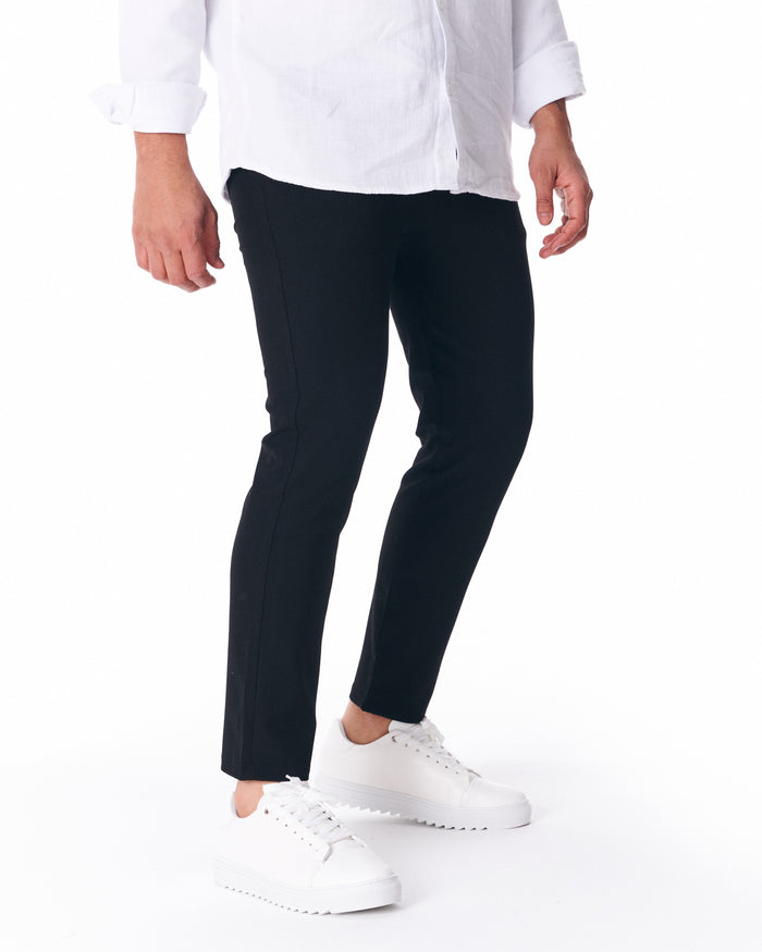 Martin Valen men's black lightweight trousers, rear-side view showing subtle seam detail and straight cropped hem