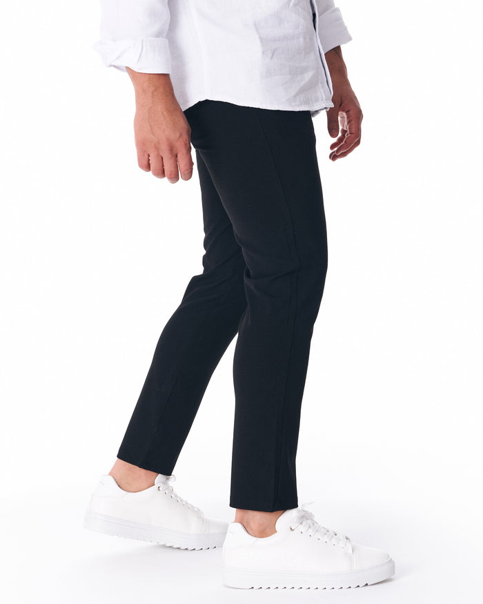 Martin Valen men's black lightweight trousers, side ankle view showing slim straight leg and cropped hem